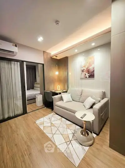 Modern living room with cozy sofa and stylish decor in a contemporary apartment.