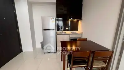 Modern compact kitchen with dining area and sleek appliances