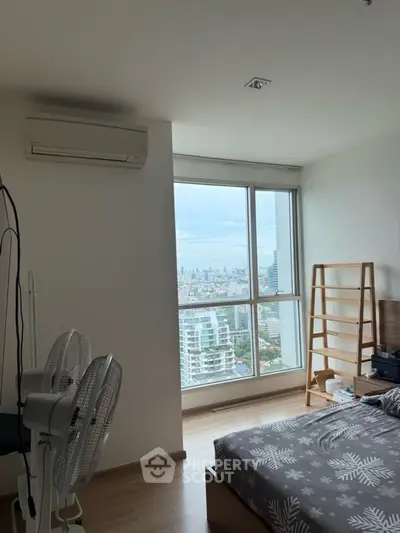 Modern bedroom with city view and air conditioning in high-rise apartment