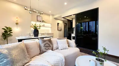 Modern living room with elegant decor and open layout, featuring cozy seating and stylish lighting.
