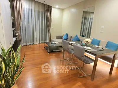 Modern living room with dining area, hardwood floors, and elegant decor