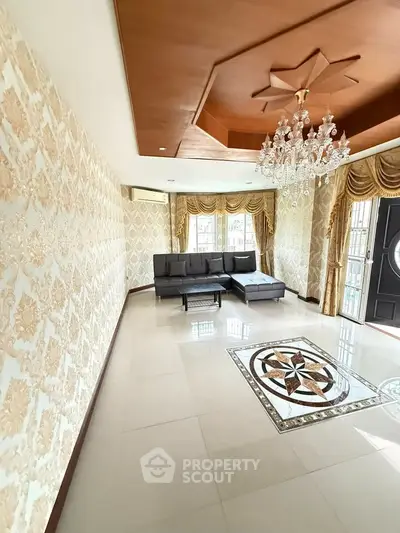 Luxurious living room with elegant chandelier and stylish decor in a spacious home.