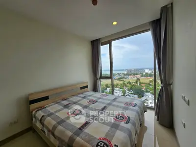 Spacious bedroom with stunning city view from large window