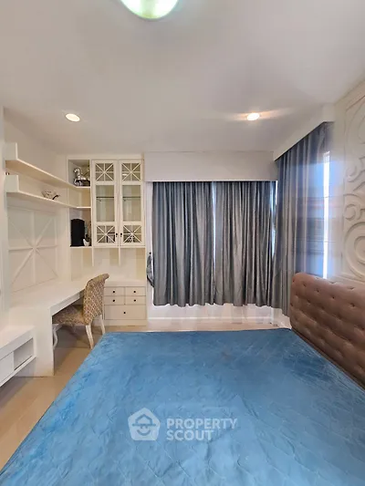 Spacious bedroom with elegant decor and built-in study area