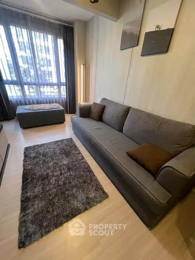 Modern living room with cozy sofa and large window in stylish apartment