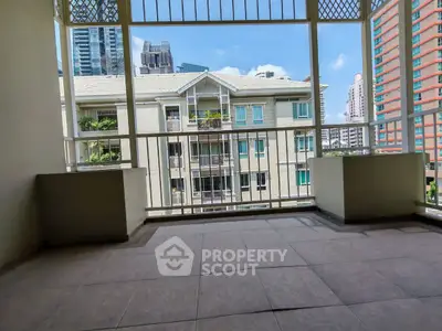 Spacious balcony with city view in modern apartment building