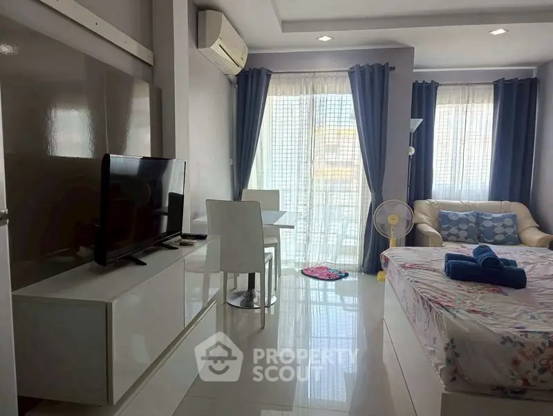 Modern studio apartment with natural light, featuring a cozy living area and stylish decor.