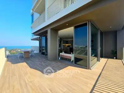 Spacious modern balcony with ocean view in luxury apartment