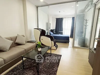 Modern living room with massage chair and glass partition to bedroom