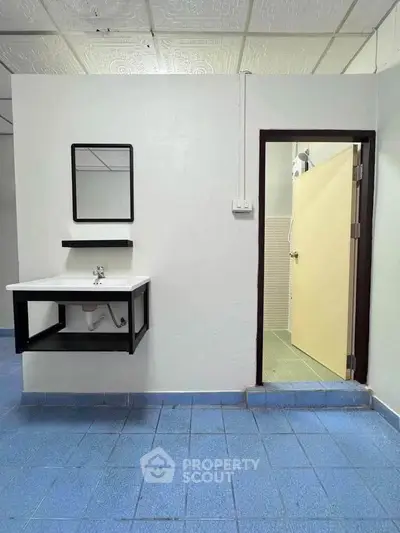 Minimalist bathroom with blue tile flooring and modern sink design