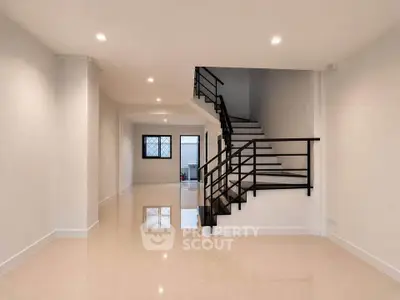 Spacious modern interior with sleek staircase and polished floors, ideal for contemporary living.