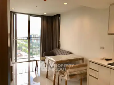 Modern living room with balcony view in high-rise apartment