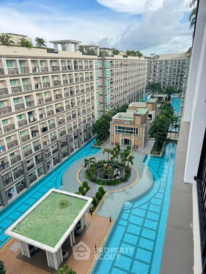 Luxurious apartment complex with stunning pool and modern architecture.