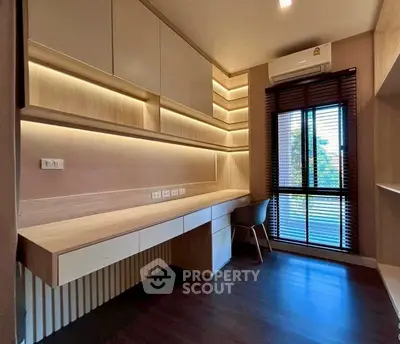 Modern study room with built-in desk and ample natural light