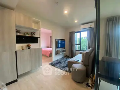 Modern living room with stylish decor and open view to bedroom