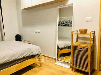 Cozy bedroom with wooden flooring, stylish mirror, and modern decor