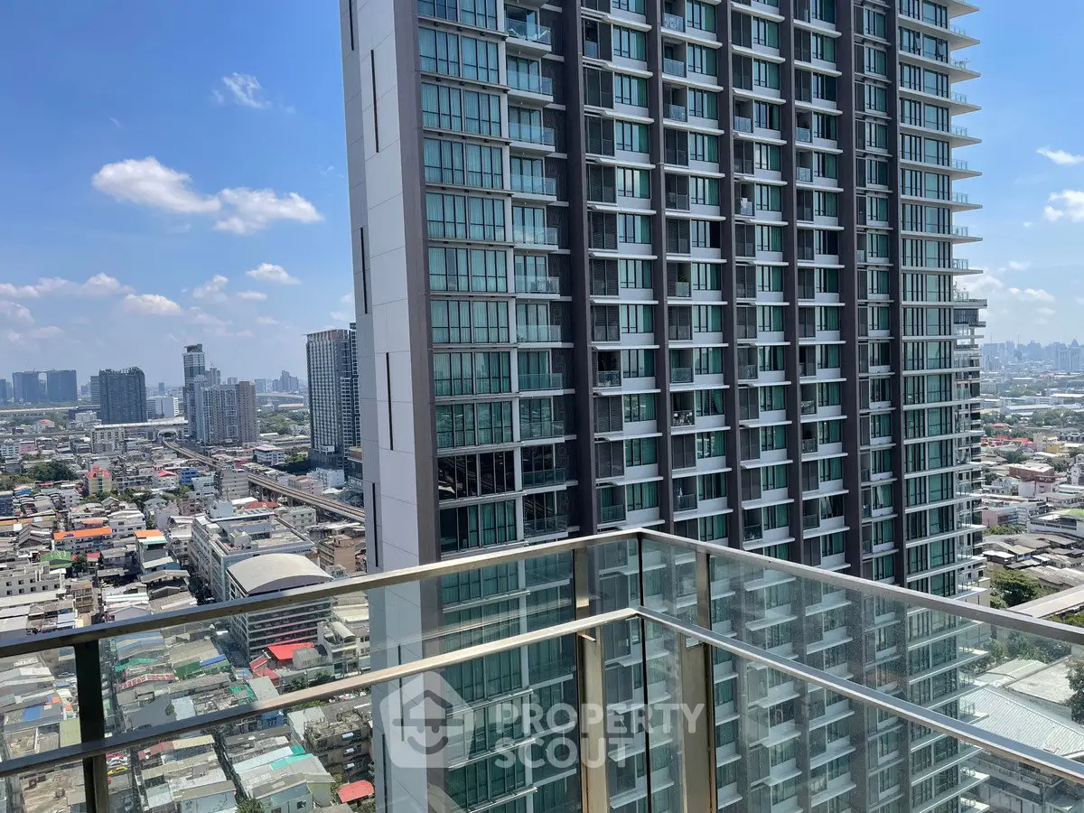 Stunning high-rise building view from a modern glass balcony overlooking the city skyline.