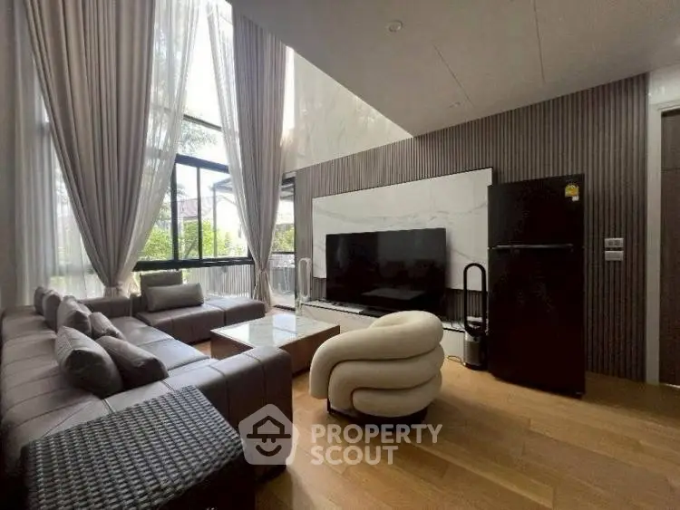 Luxurious living room with modern furniture and large windows