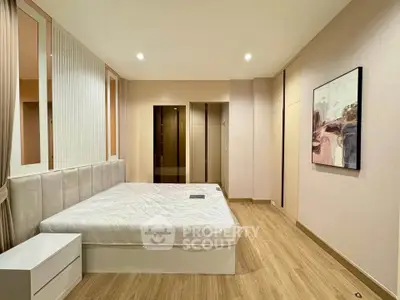 Spacious modern bedroom with elegant decor and wooden flooring