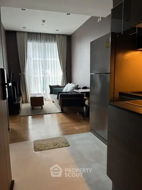 Modern living room with open kitchen and stylish decor in a cozy apartment.