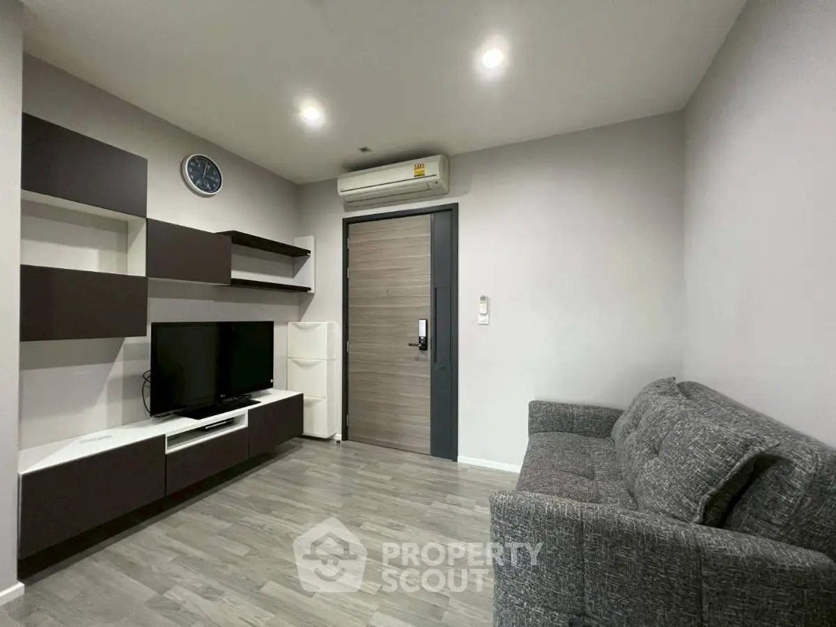 Modern living room with sleek furniture and air conditioning in a cozy apartment.