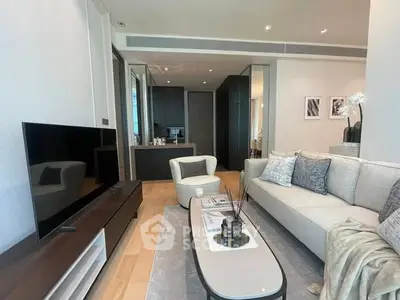 Modern living room with sleek furniture and open kitchen layout