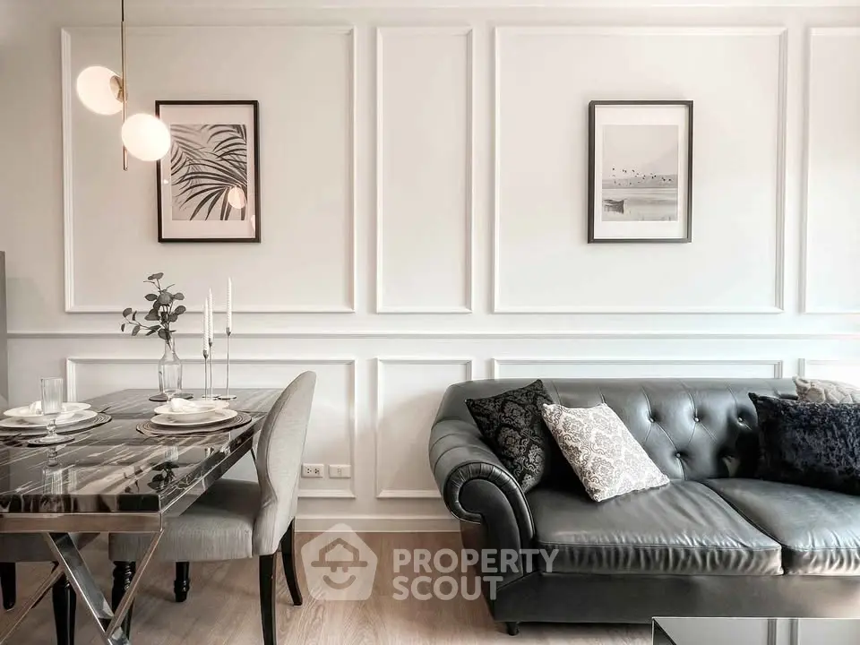 Elegant living room with chic decor, featuring a stylish sofa and modern dining area, perfect for urban living.