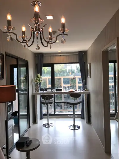 Stylish modern living room with chandelier and balcony view