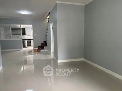 Spacious modern interior with glossy tiled floors and open kitchen layout, perfect for contemporary living.