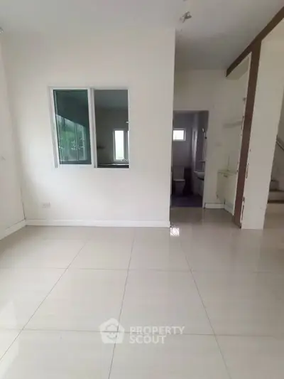 Spacious interior with tiled flooring and neutral walls, perfect for customization.