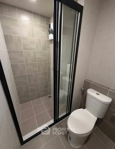 Modern bathroom with sleek shower and toilet in neutral tones