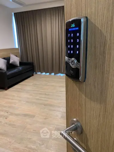 Modern living room with smart lock on wooden door, featuring sleek sofa and elegant curtains.
