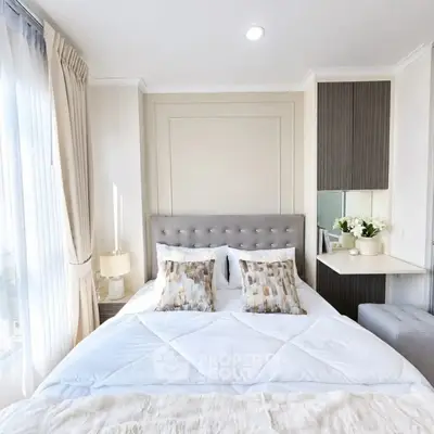 Elegant bedroom with plush bedding and natural light in modern apartment