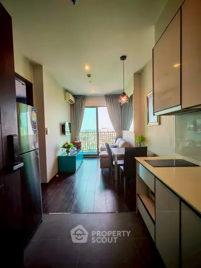Modern open-layout kitchen and living area with balcony view