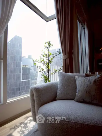 Modern living room with cozy sofa and panoramic city view through large windows.
