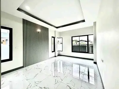 Spacious modern living room with elegant marble flooring and large windows