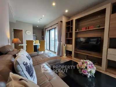 Spacious living room with modern decor and large windows in a stylish apartment.