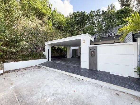Charming modern home with spacious driveway and lush greenery