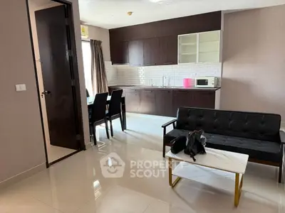 Modern open-layout living room with sleek kitchen and stylish furniture