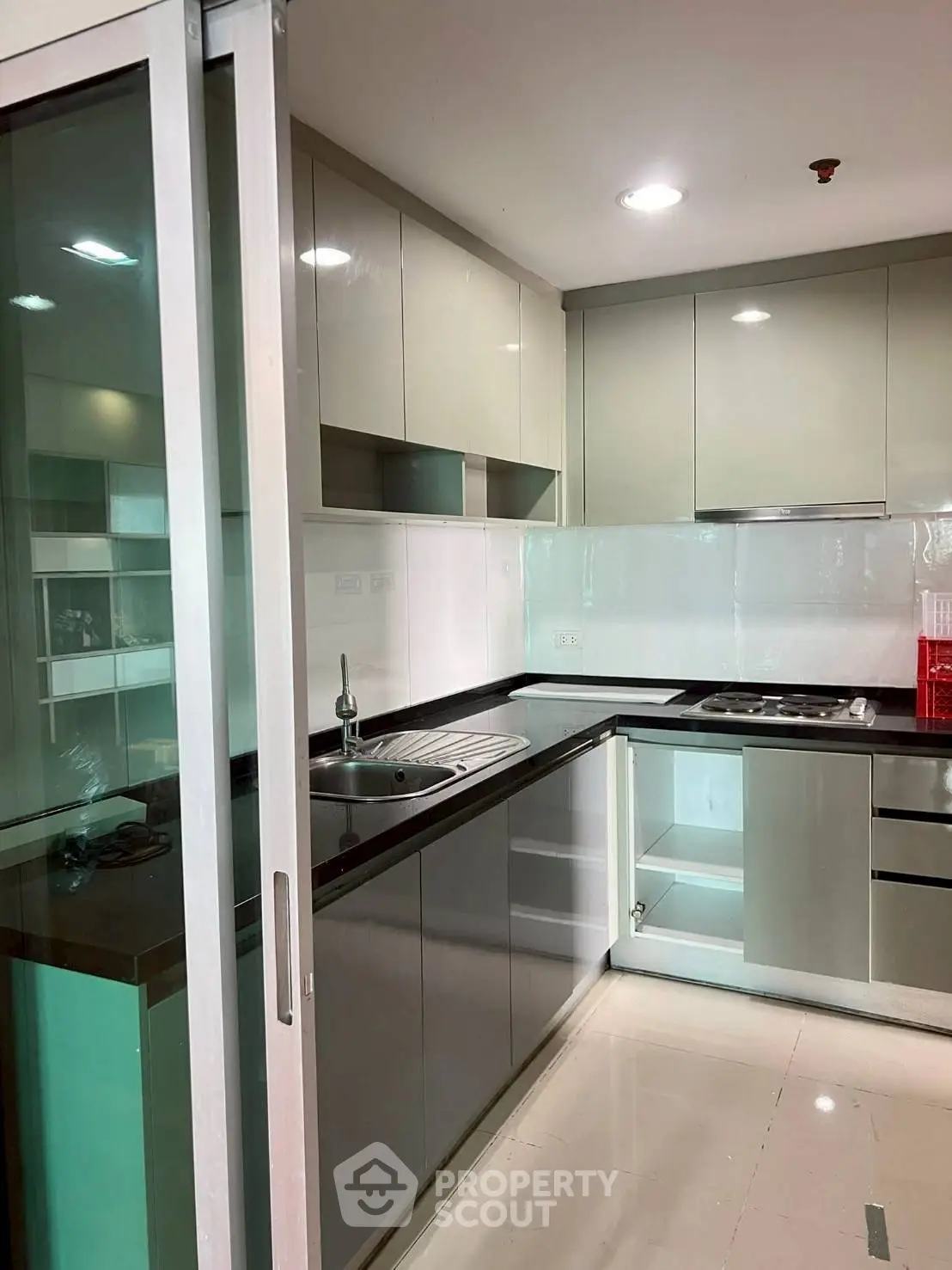 Modern kitchen with sleek cabinetry and glass sliding door