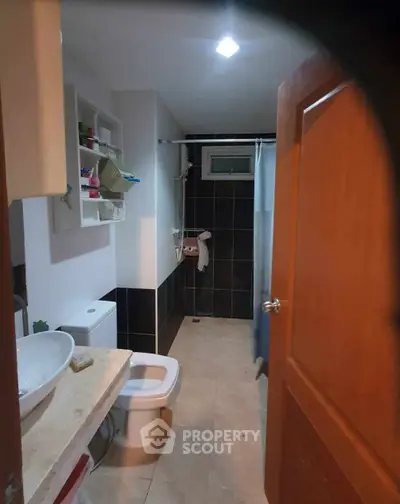 Modern bathroom with sleek fixtures and stylish black and white tiles.