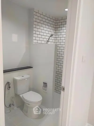 Modern bathroom with sleek white tiles and contemporary fixtures