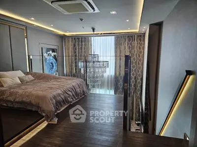 Luxurious bedroom with modern design and elegant chandelier in high-rise apartment.