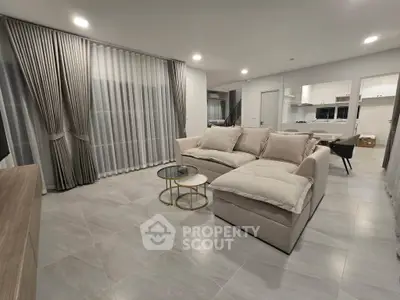 Spacious modern living room with elegant decor and open kitchen layout
