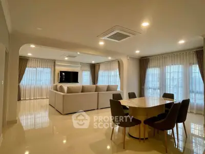 Spacious modern living room with elegant dining area and large windows