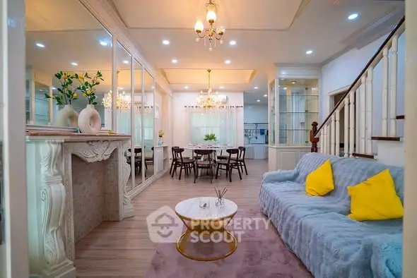 Elegant living room with plush sofa, stylish decor, and dining area in a luxurious home.