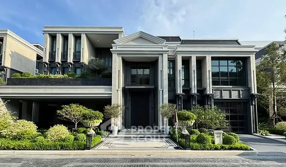 Luxurious modern mansion with grand entrance and lush landscaping