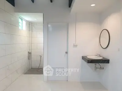 Modern bathroom with sleek white tiles and minimalist design