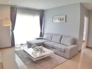 Elegant living room with modern gray sofa and natural light