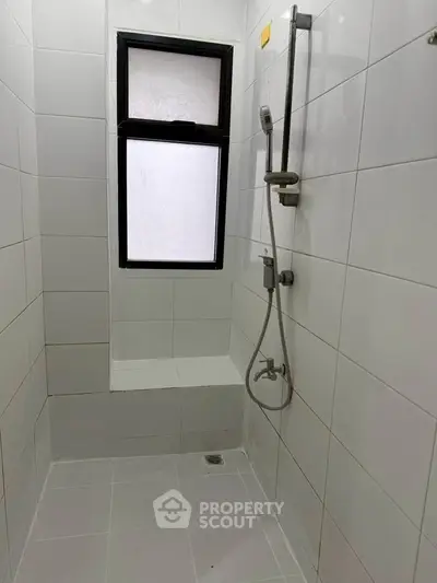 Modern bathroom with sleek shower and window for natural light